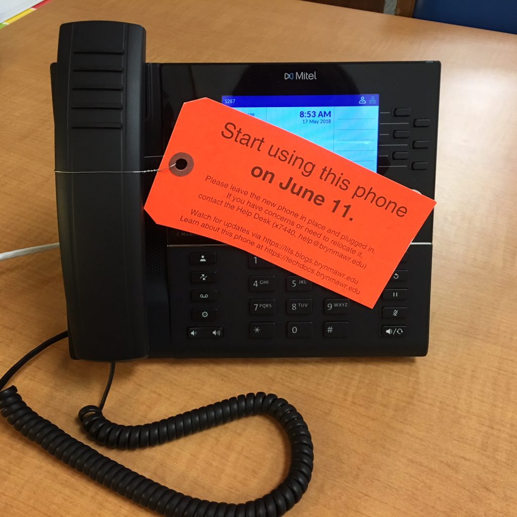 new College phone showing tag instructing community members to begin using this phone on June 11